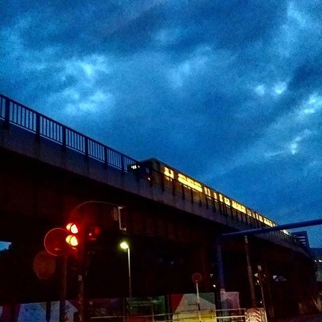 sky, low angle view, architecture, built structure, illuminated, cloud - sky, transportation, building exterior, dusk, cloud, street light, connection, bridge - man made structure, night, cloudy, lighting equipment, outdoors, railing, no people, city