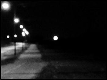 Defocused image of illuminated street lights at night