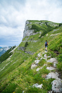 Rear view of people on mountain against sky