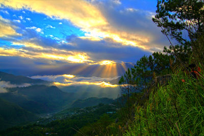 Scenic view of mountains against sky at sunset