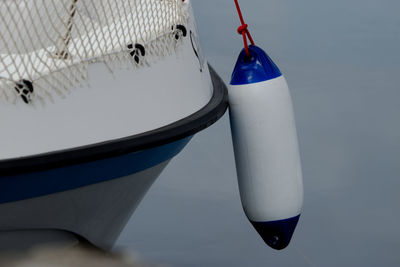 Side of a white boat with boat buoy