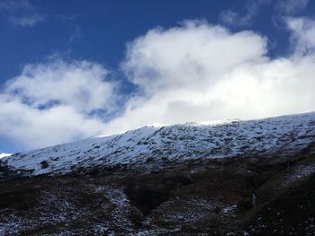 Low angle view of snowcapped mountain against sky