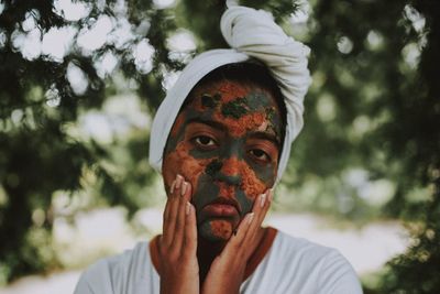 Portrait of man wearing mask against trees