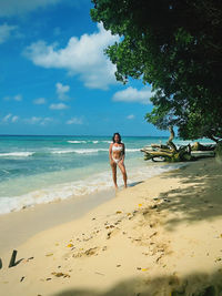 Front view of woman standing at beach