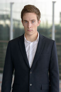 Portrait of young man standing at home