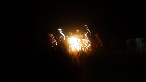 Close-up of illuminated hands at night