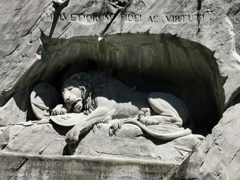 Low angle view of statue against stone wall