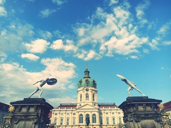 Low angle view of building against cloudy sky