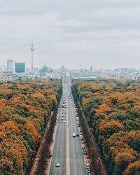 Street amidst trees against sky