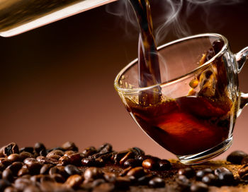 Close-up of coffee beans in glass on table