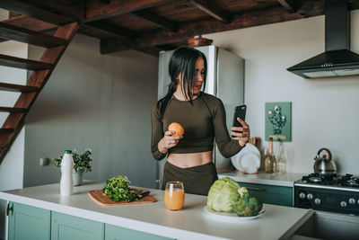 Full length of woman having food at home