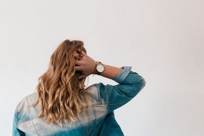 Young woman standing against white background