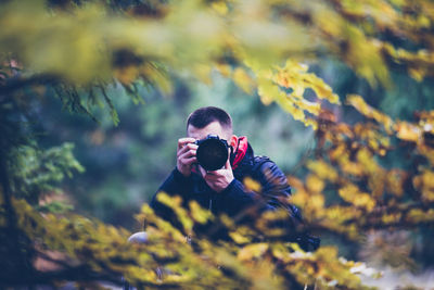 Midsection of woman photographing with mobile phone