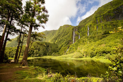 Amazing waterfalls, lake with reflection, water, green landscape, azores islands.