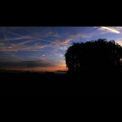 Silhouette landscape against sky at sunset