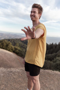 Full length of man standing on land against sky