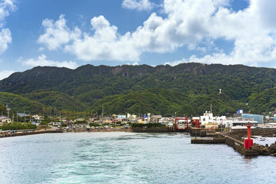 Scenic view of sea and mountains against sky