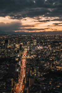 High angle view of illuminated cityscape against sky at night