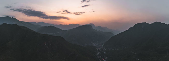 Scenic view of silhouette mountains against sky during sunset