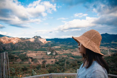 Side view of woman looking at mountains