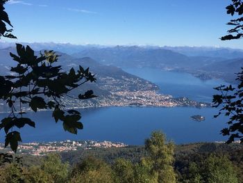 Scenic view of sea and mountains against clear blue sky