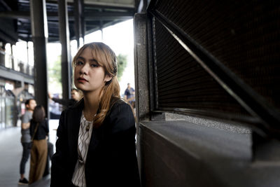 Portrait of young woman standing in office