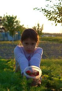 Portrait of girl standing by plants