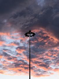 Low angle view of street light against cloudy sky