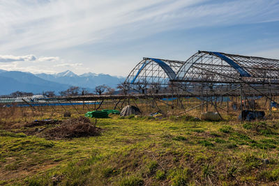 Farm at susuki river in matsumoto suburb with central snow alps background, nagano, japan.