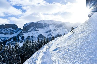 Scenic view of snow covered mountains against sky