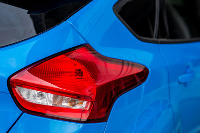 Close-up of red car against blue sky