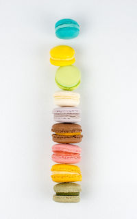 Delicious macarons tower on white background