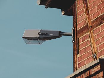 Low angle view of buildings against clear blue sky