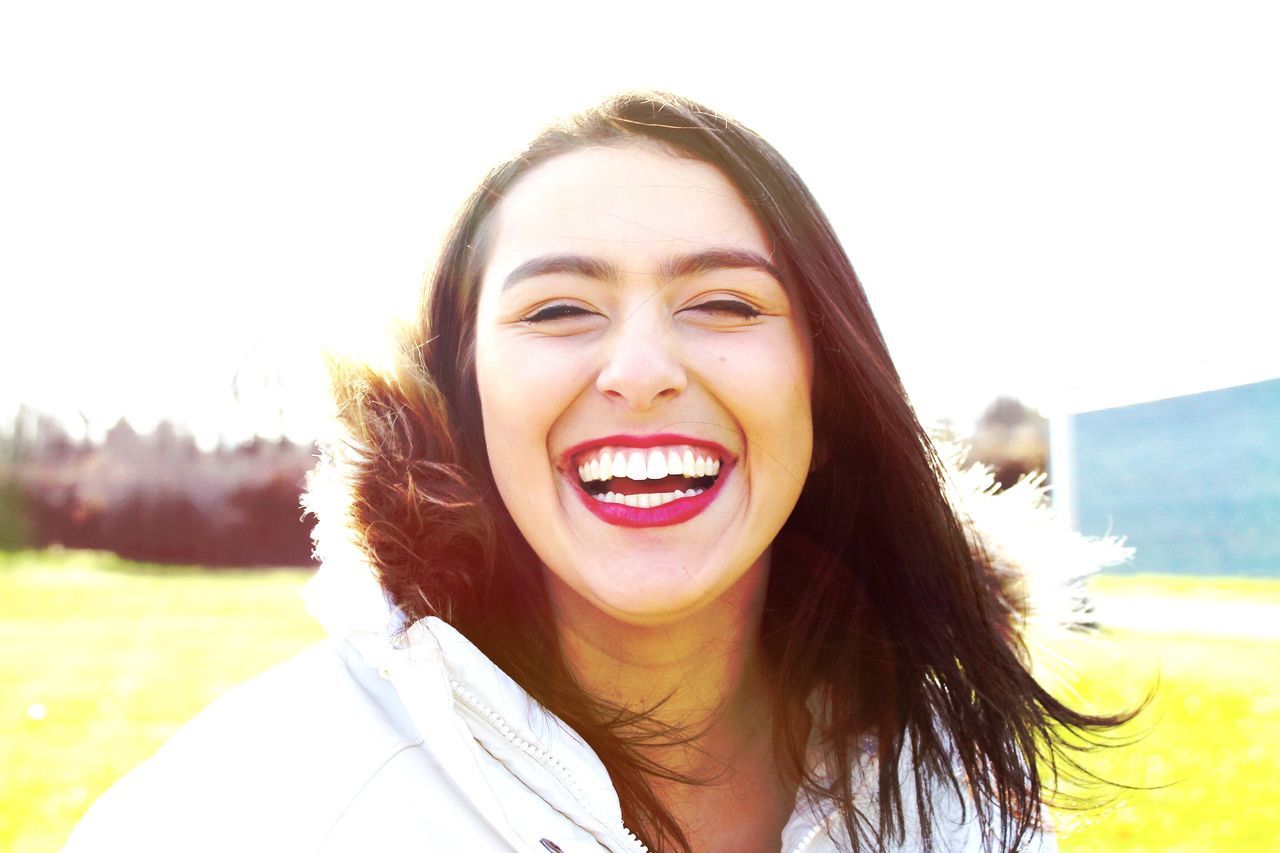 portrait, person, looking at camera, young adult, headshot, lifestyles, young women, front view, long hair, smiling, leisure activity, happiness, head and shoulders, brown hair, toothy smile, casual clothing, blond hair