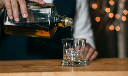 Midsection of wineglass on table