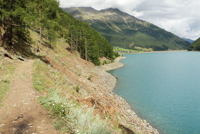 Scenic view of sea and mountains against sky