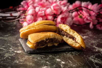 Close-up of bread on table against black background