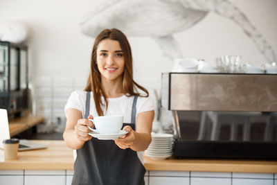 Young woman holding coffee cup