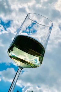 Low angle view of wine glass against sky