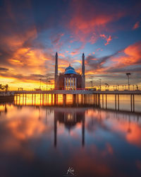 Scenic view of building against sky during sunset