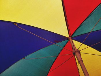 Low angle view of umbrella against blue sky