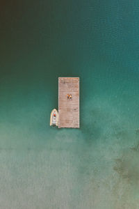 High angle view of blue paint on wood against wall