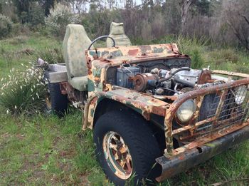 Abandoned car on field