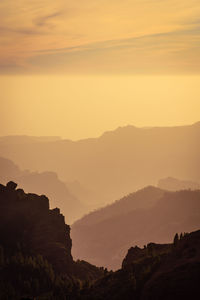 Scenic view of mountains against sky during sunset