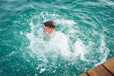 High angle view of man swimming in sea