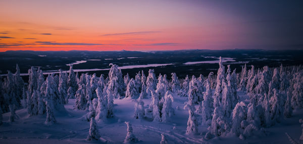 Panoramic shot of frozen landscape against sky during winter