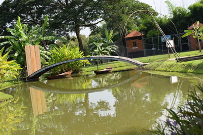 Reflection of tree and building in lake