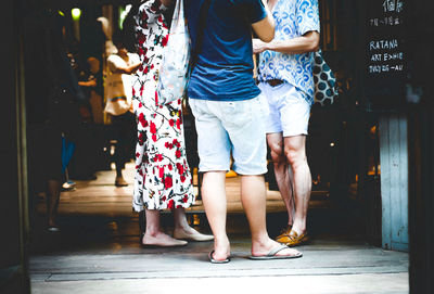 Low section of people standing on floor in city