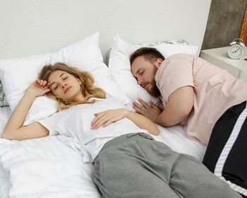 Young woman sleeping on bed at home