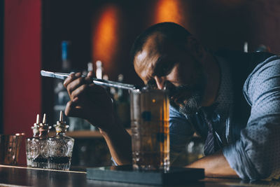 Bartender making drink at counter